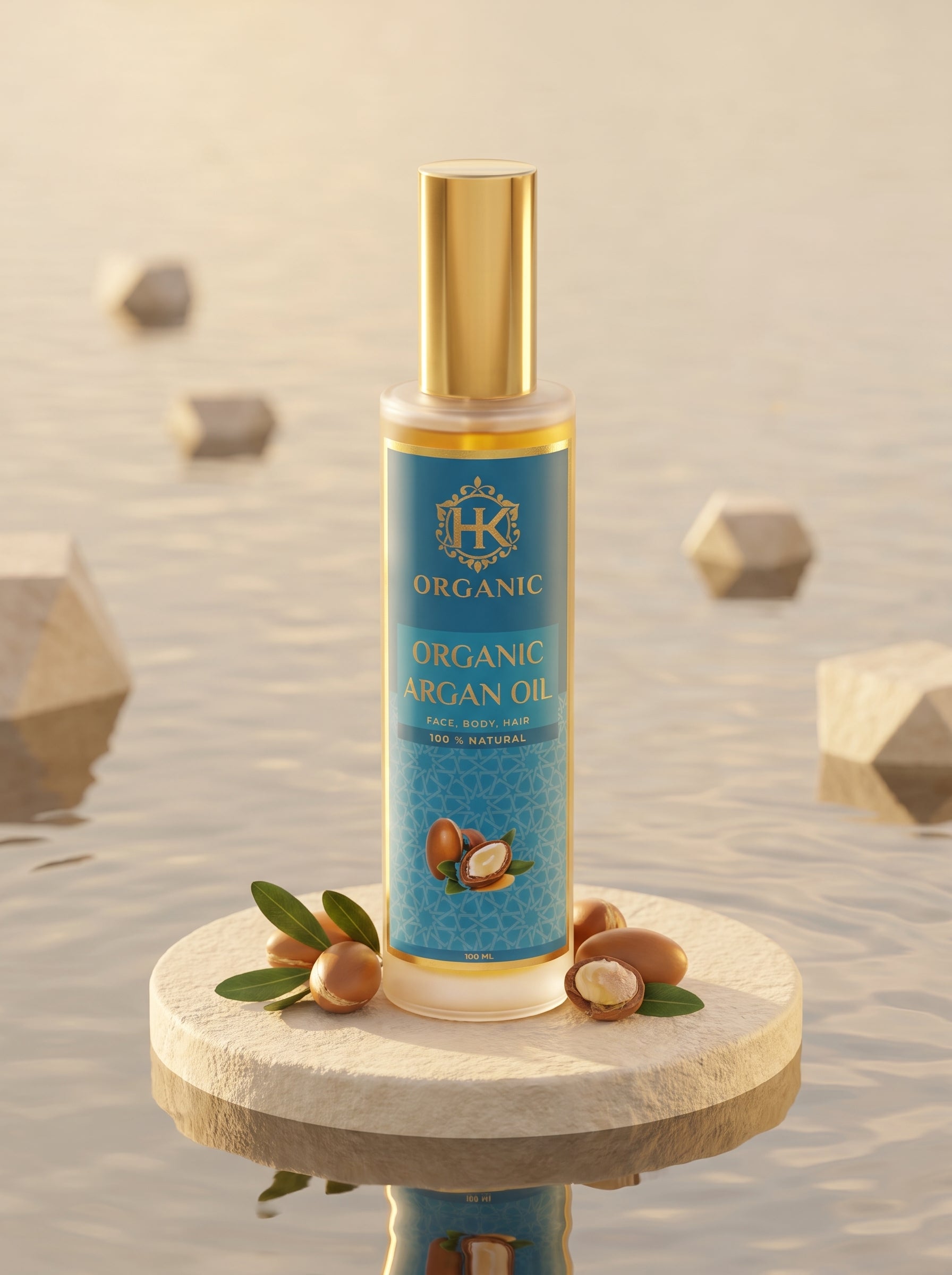 A bottle of Organic Argan Oil by HK Organic stands on a round stone pedestal. The bottle has a blue label with gold lettering and a gold cap, surrounded by argan nuts and green leaves.