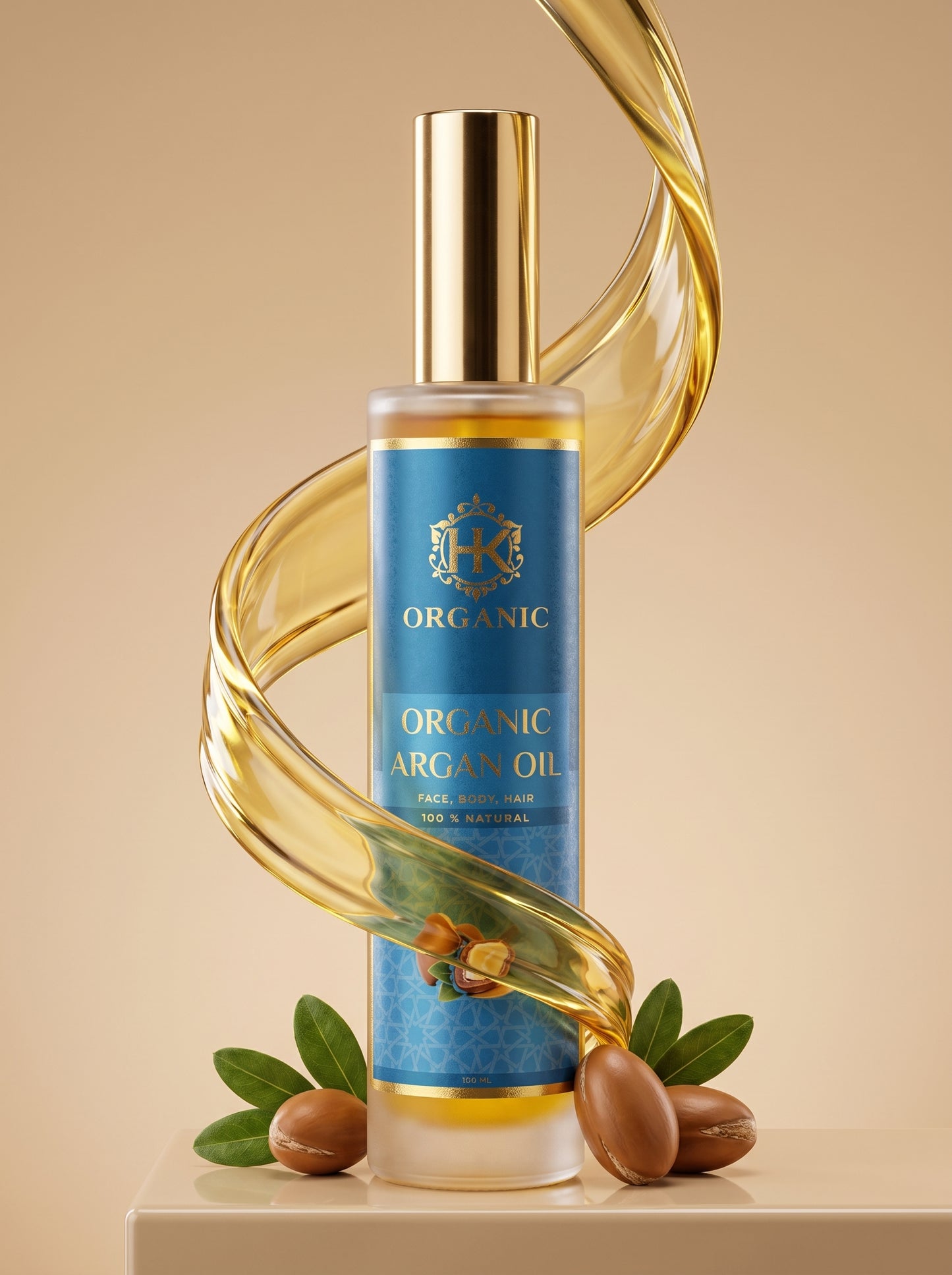 A bottle of Organic Argan Oil stands on a beige pedestal against a warm beige background, wrapped by a glossy translucent gold ribbon. The bottle has a blue label with gold lettering and is decorated with argan nuts and green leaves at the base.